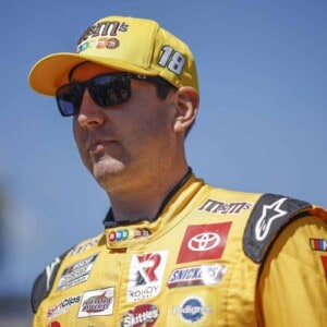 KANSAS CITY, KANSAS - SEPTEMBER 11: Kyle Busch, driver of the #18 M&M's Toyota, walks the grid prior to the NASCAR Cup Series Hollywood Casino 400 at Kansas Speedway on September 11, 2022 in Kansas City, Kansas. (Photo by Chris Graythen/Getty Images)