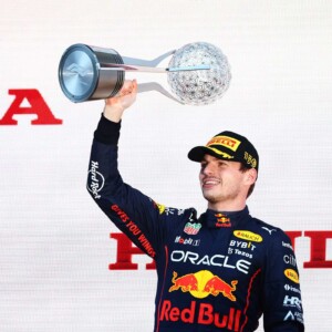 SUZUKA, JAPAN - OCTOBER 09: Race winner and 2022 F1 World Drivers Champion Max Verstappen of Netherlands and Oracle Red Bull Racing Max Verstappen of the Netherlands and Oracle Red Bull Racing celebrates on the podium during the F1 Grand Prix of Japan at Suzuka International Racing Course on October 09, 2022 in Suzuka, Japan.