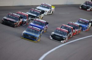 Zane Smith, driver of the #38 Love's/Speedco Ford, Chase Purdy, driver of the #4 Bama Buggies Chevrolet, and Corey Heim, driver of the #11 Safelite Toyota, race during the NASCAR Craftsman Truck Series Heart of America 200 at Kansas Speedway on May 06, 2023 in Kansas City, Kansas. (Photo by Jonathan Bachman/Getty Images)