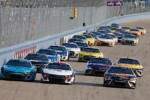 Front of NASCAR Cup Series cars of Ross Chastain, William Byron and Martin Truex Jr. pack racing in the Ally 400 at Nashville Superspeedway, NKP