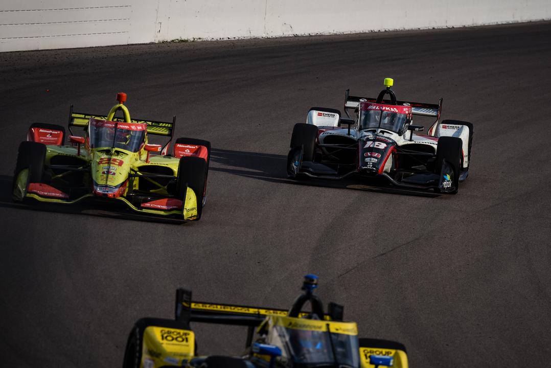 David Malukas and Devlin DeFrancesco race side by side at the 2022 NTT IndyCar Series Bommarito Automotive Group 500 at World Wide Technology Raceway.