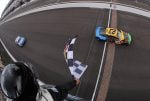 Bubba Wallace, driver of the #23 Chumba Casino Toyota, takes the checkered flag to win the NASCAR Cup Series Brickyard 400 Presented by PPG at Indianapolis Motor Speedway on July 27, 2025 in Indianapolis, Indiana. (Photo by Jonathan Bachman/Getty Images)