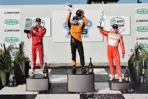 Pato O'Ward, Josef Newgarden and Will Power on the podium following the first race of the NTT IndyCar Series' 2025 doubleheader at Iowa.