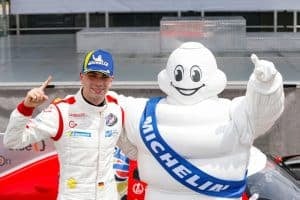 Valentino Catalano celebrates his victory in IMSA VP Racing SportsCar Challenge Race No. 2 at VIR with the Michelin Man, Bibendium, 8/23/2025 (Photo: Courtesy of IMSA)
