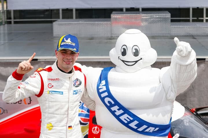 Valentino Catalano celebrates his victory in IMSA VP Racing SportsCar Challenge Race No. 2 at VIR with the Michelin Man, Bibendium, 8/23/2025 (Photo: Courtesy of IMSA)