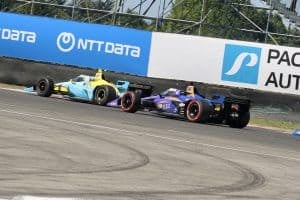 Conor Daly and Christian Rasmussen race during the NTT IndyCar Series 2025 race at Portland International Raceway.