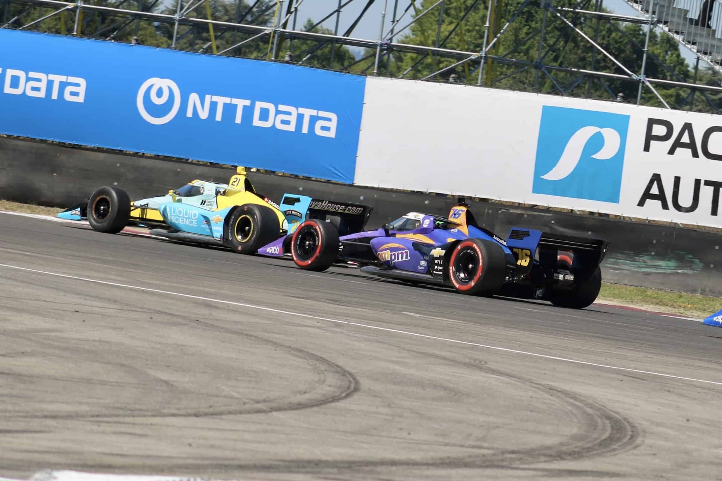Conor Daly and Christian Rasmussen race during the NTT IndyCar Series 2025 race at Portland International Raceway.