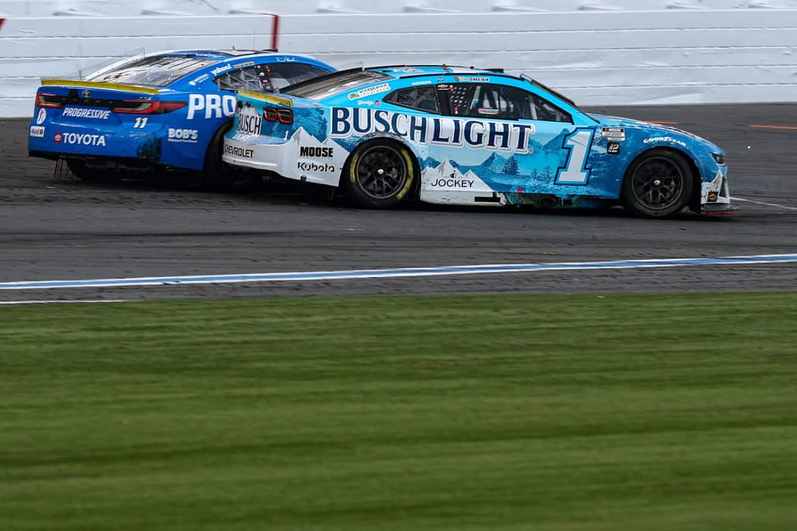 Ross Chastain, driver of the #1 Busch Light Chevrolet, and Denny Hamlin, driver of the #11 Progressive Toyota, spin after an on-track incident to finish the race in reverse the NASCAR Cup Series Bank of America ROVAL 400 at Charlotte Motor Speedway on October 05, 2025 in Concord, North Carolina. (Photo by Jared C. Tilton/Getty Images)