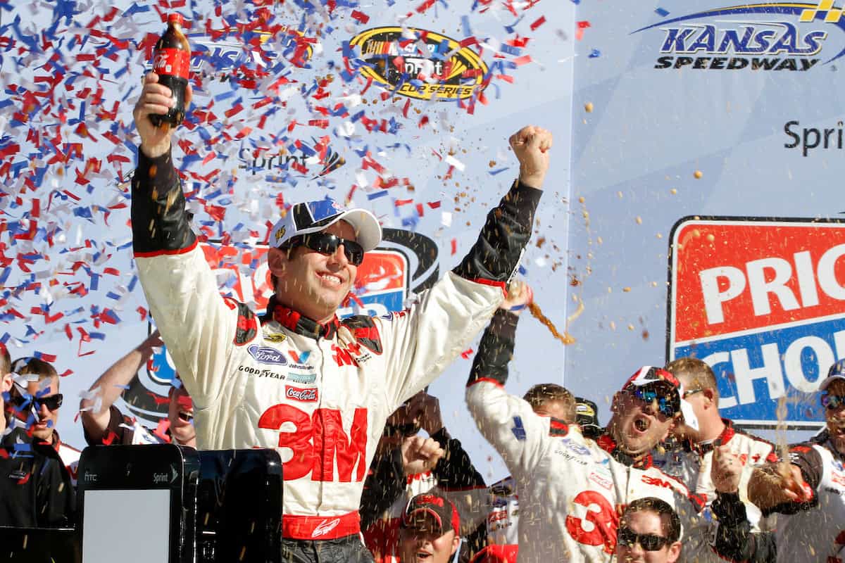 1 - 3 October , 2010, Kansas City, Kansas USA Greg Biffle celebrates on top of his Ford Fusion in Victory Lane after winning the Price Chopper 400 at the Kansas Speedway. © 2010 - Tyler Barrick Autostock