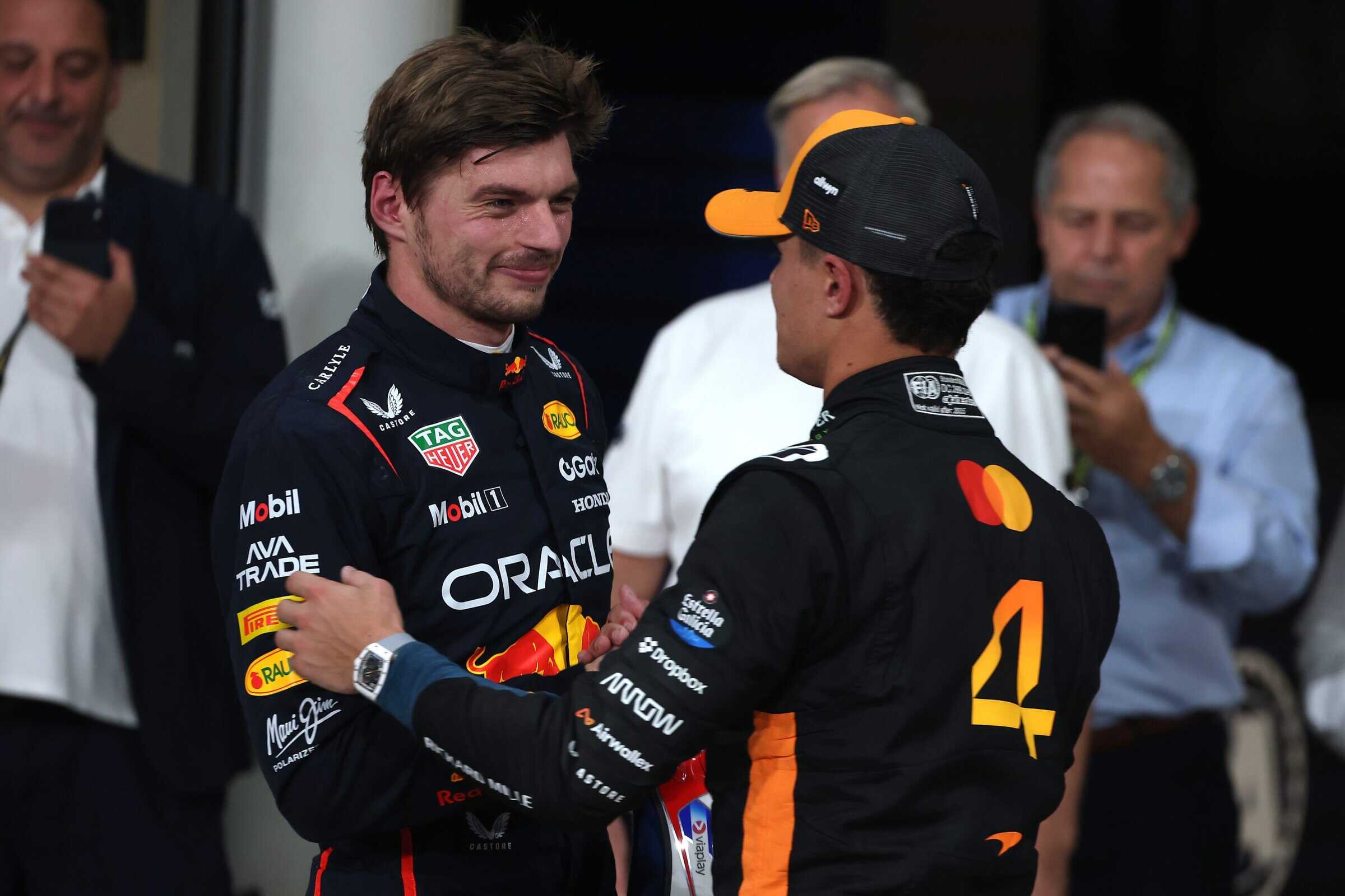 ABU DHABI, UNITED ARAB EMIRATES - DECEMBER 06: Pole position qualifier Max Verstappen of the Netherlands and Oracle Red Bull Racing and Second placed qualifier Lando Norris of Great Britain and McLaren congratulate each other in parc ferme during qualifying ahead of the F1 Grand Prix of Abu Dhabi at Yas Marina Circuit on December 06, 2025 in Abu Dhabi, United Arab Emirates. (Photo by Sam Bloxham/LAT Images) // Getty Images / Red Bull Content Pool // SI202512060471 // Usage for editorial use only //