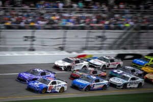 NASCAR Cup Series cars led by Cody Ware and Bubba Wallace pack racing at Daytona International Speedway