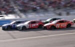 MADISON, ILLINOIS - SEPTEMBER 13: Kyle Larson, driver of the #5 HendrickCars.com Chevrolet, Josh Berry, driver of the #21 DEX Ford, and Denny Hamlin, driver of the #11 King's Hawaiian Cinnamon Bites Toyota, race during the NASCAR Cup Series Enjoy Illinois 300 at WWT Raceway on September 13, 2026 in Madison, Illinois.